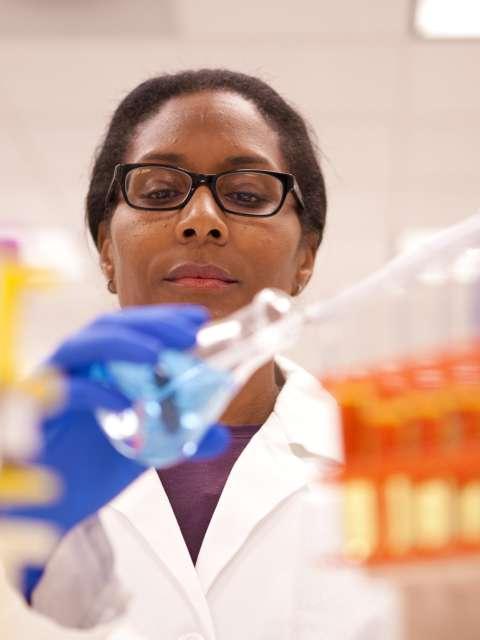 A doctor holding a beaker in lab.